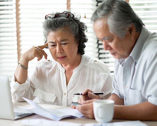 older couple paying household bills