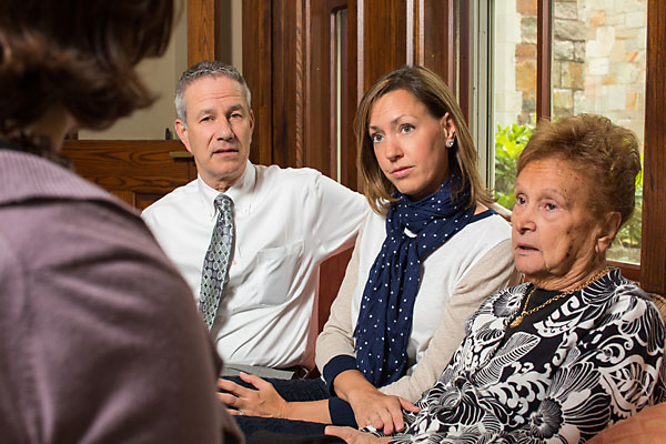 Jenny Miller meeting with a client and her family to discuss memory loss